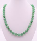 A string of green beads. 66 cm long.