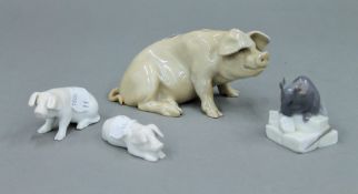 A Royal Copenhagen porcelain mouse and three pigs. The largest 12.5 cm long.