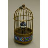 A cloisonne birdcage clock. 18 cm high.