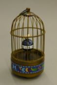 A cloisonne birdcage clock. 18 cm high.