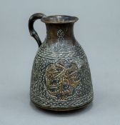 An antique Islamic mix metal jug. 9 cm high.