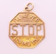 A 9 ct gold ' I'LL NEVER STOP LOVING YOU' charm. 2 cm wide. 2.5 grammes.