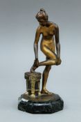 An Art Deco bronze model of a nude girl mounted on a marble plinth base. 15 cm high.