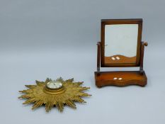 A Victorian toilet mirror and a sunburst clock. The former 36.5 cm wide.