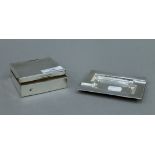 A silver ashtray, a silver vesta and a silver cigarette box. The ashtray 11 cm wide.