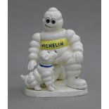 A cast iron model of the Michelin Man and his dog. 19 cm high.