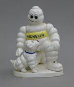A cast iron model of the Michelin Man and his dog. 19 cm high.