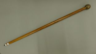 A walking stick with a four faced Buddha form handle. 92.5 cm long.