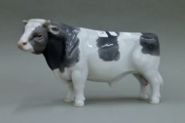 A large Royal Copenhagen porcelain bull. 34 cm long.