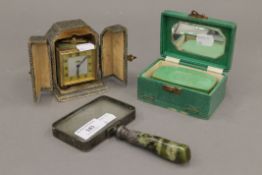 A cased clock, a magnifying glass and a box. The magnifying glass 17 cm long.