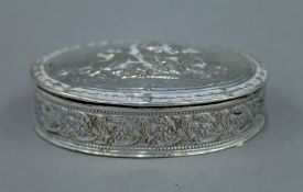 An 800 silver embossed box. 7.5 cm wide. 76.1 grammes.