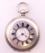 A silver half hunter cased pocket watch. 4.5 cm diameter.
