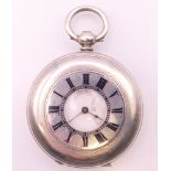 A silver half hunter cased pocket watch. 4.5 cm diameter.