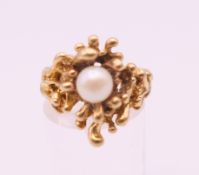 A Contemporary 10 K gold pearl set ring. Ring size N/O. 7.8 grammes total weight.