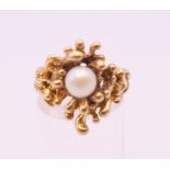 A Contemporary 10 K gold pearl set ring. Ring size N/O. 7.8 grammes total weight.