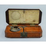 A 19th century boxed set of diamond scales. 13 cm wide.