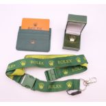 A Rolex lanyard, a Rolex credit card holder wallet and a Rolex lapel pin badge.