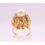 A Contemporary unmarked gold domed pearl set ring. Ring size L. 10.3 grammes total weight.