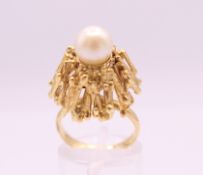 A Contemporary unmarked gold domed pearl set ring. Ring size L. 10.3 grammes total weight.