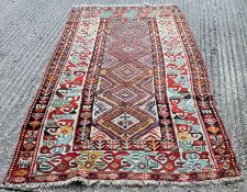 A red ground wool rug. 265 x 123 cm.
