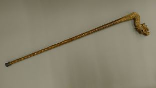 A walking stick with a wooden dragon form handle. 92 cm long.