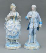 A pair of 19th century Continental porcelain figures. The largest 31 cm high.