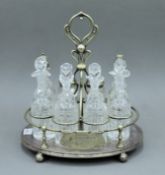 An eight piece silver plated cruet stand. 35 cm high.