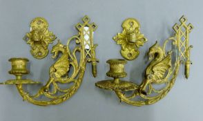 A pair of gilded brass candle sconces.