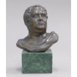 A small bronze bust of a Roman figure on a plinth base. 13 cm high.