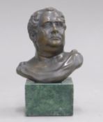 A small bronze bust of a Roman figure on a plinth base. 13 cm high.