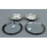 A pair of silver bon bon dishes, hallmarked for Birmingham 1899 and a pair of bottle coasters.