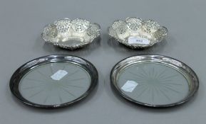 A pair of silver bon bon dishes, hallmarked for Birmingham 1899 and a pair of bottle coasters.