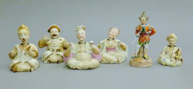 A collection of 19th century porcelain nodding head figures. The largest 14 cm high.