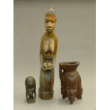 Three African wooden figures. The largest 64 cm high.