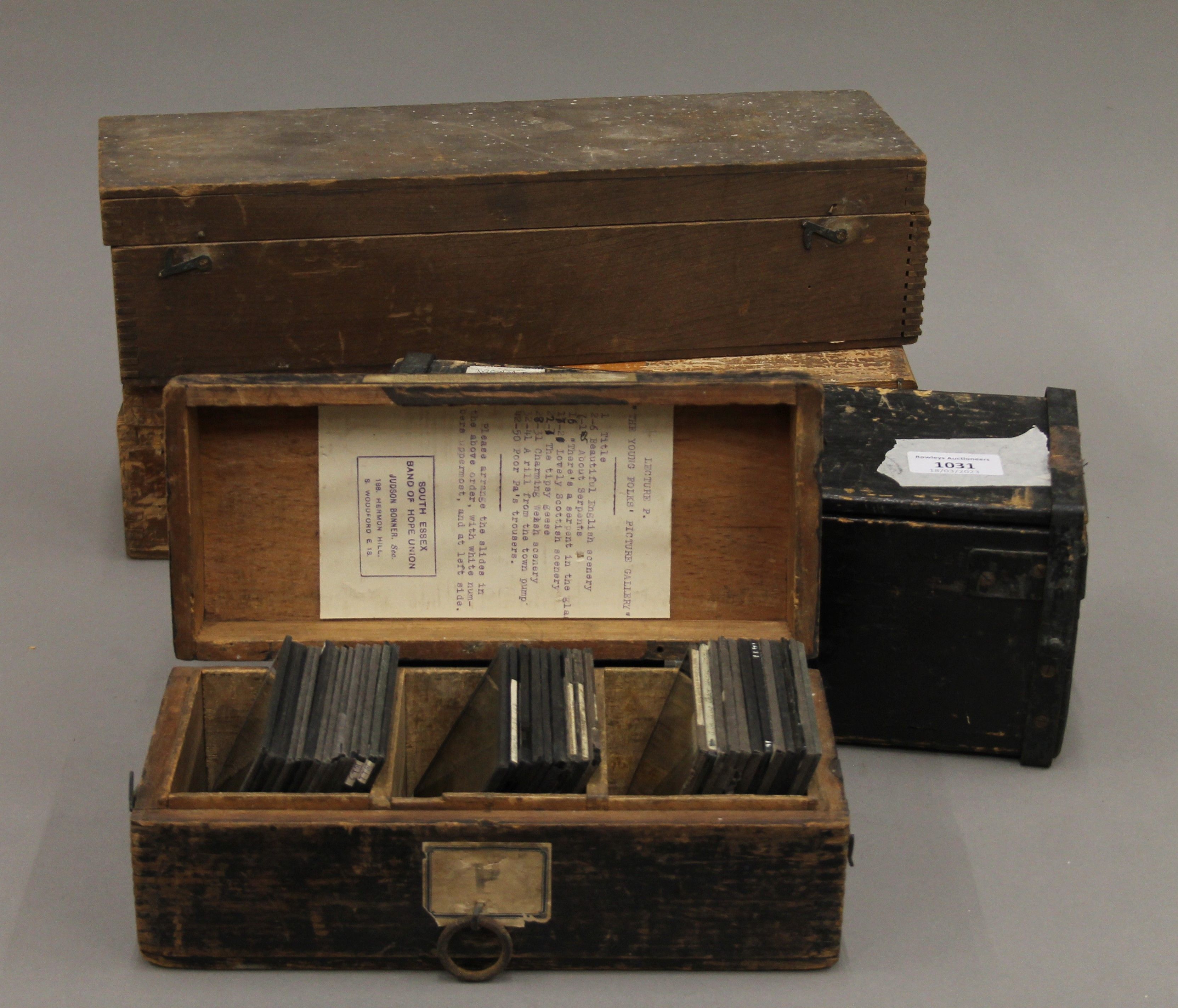 Four boxes of antique magic lantern slides.