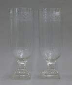A pair of glass storm lamps. 34.5 cm high.