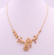 A 15 ct gold and seed pearl set necklace, cased. Approximately 40 cm long. 11.