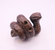 A wooden netsuke formed as a snake. 5 cm wide.