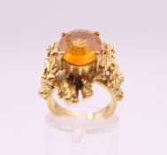 A Contemporary citrine set gold ring, possibly 15 ct gold. Ring size J/K. 9.4 grammes total weight.