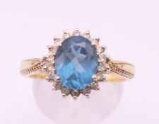 A gold diamond and topaz ring. Ring size S.