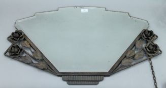 An Art Deco mirror with floral decoration. 79 cm wide.