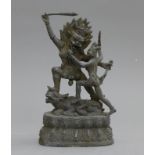 A bronze model of warring deity.