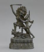 A bronze model of warring deity.