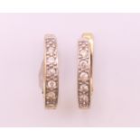 A pair of 9 ct gold diamond earrings. 1.5 cm high. 2.3 grammes total weight.