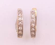 A pair of 9 ct gold diamond earrings. 1.5 cm high. 2.3 grammes total weight.