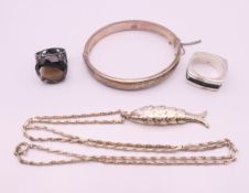 Two silver rings, a silver bangle and an articulated fish pendant necklace. Fish 5 cm long.