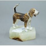 A cold painted white metal model of a beagle on a plinth base. 8 cm high overall.