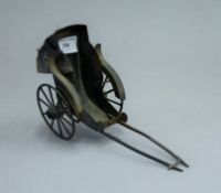 An early 20th century faux tortoiseshell toy rickshaw. 21.5 cm long.