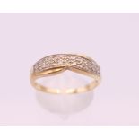 A 9 ct gold diamond set ring. Ring size S/T. 2.3 grammes total weight.