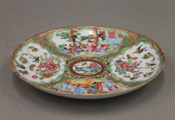 A 19th century Canton famille rose plate. 21.5 cm diameter.